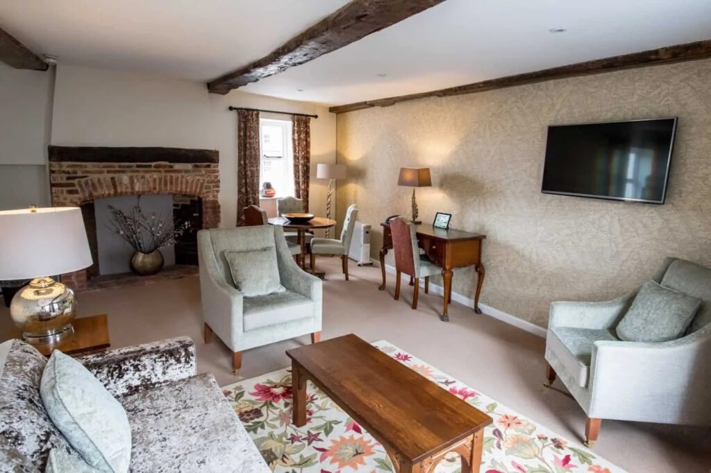 The sitting room with its fireplace and armchairs