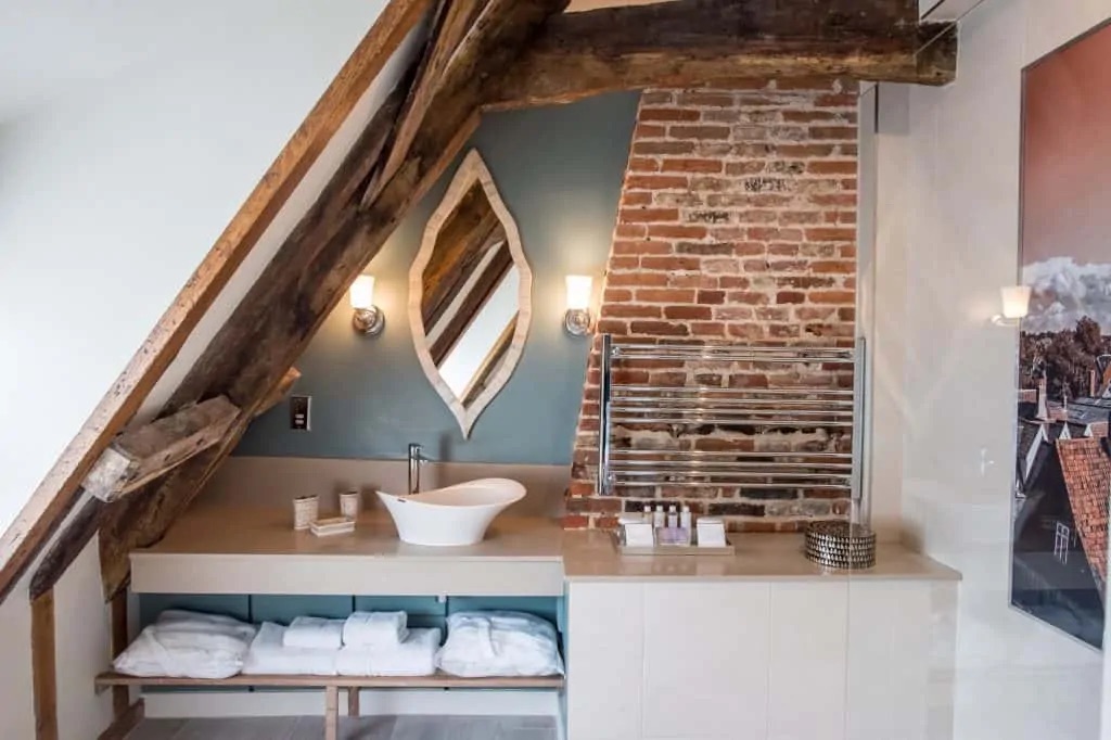 Twin basins beside an exposed brick chimney breast
