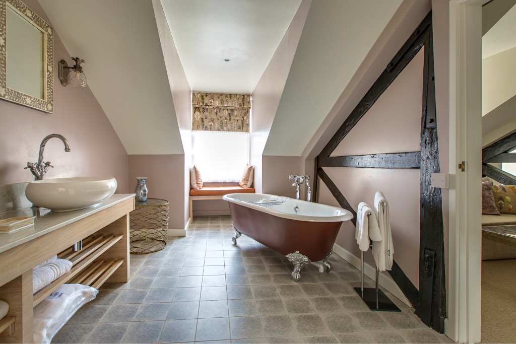 A roll-top bath and basin in the Wensum Suite's bathroom
